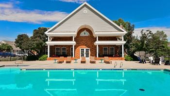 A house with a pool in front of it. at The Donovan Apartment Homes, Lincoln, NE, 68516